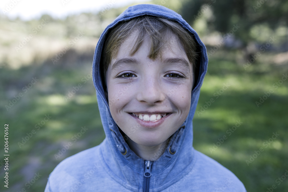 Portrait of laughing boy wearing blue hooded jacket Portrait of laughing boy wearing blue hooded jacket
