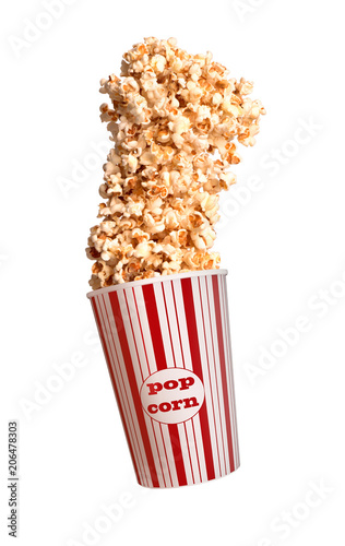 Popcorn flies out of a paper cup on a white background