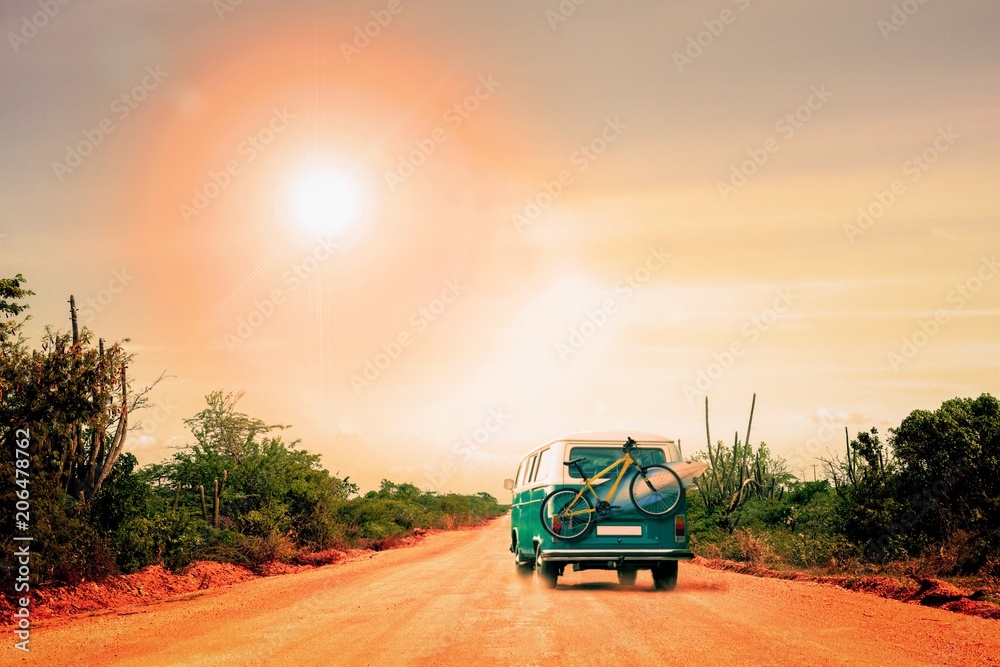 Fototapeta premium Traveling camper with bike and surfboard in Australia. Holiday trip in motorhome, Caravan car Vacation