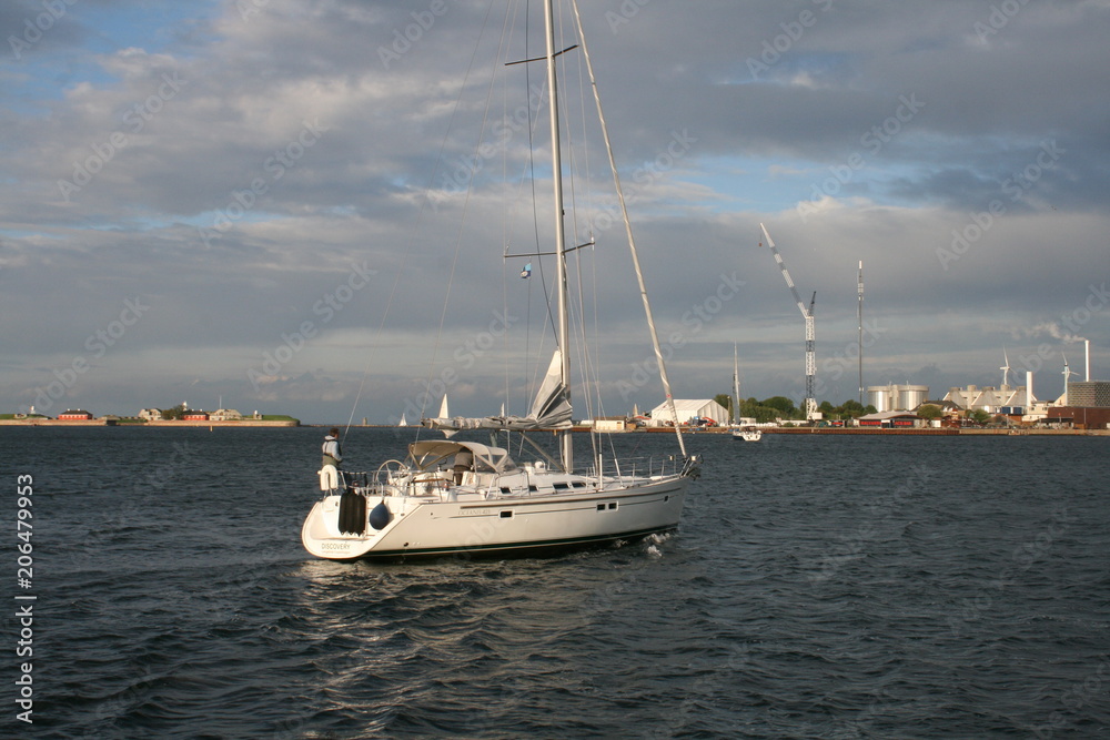 white sailboat in the sea bay