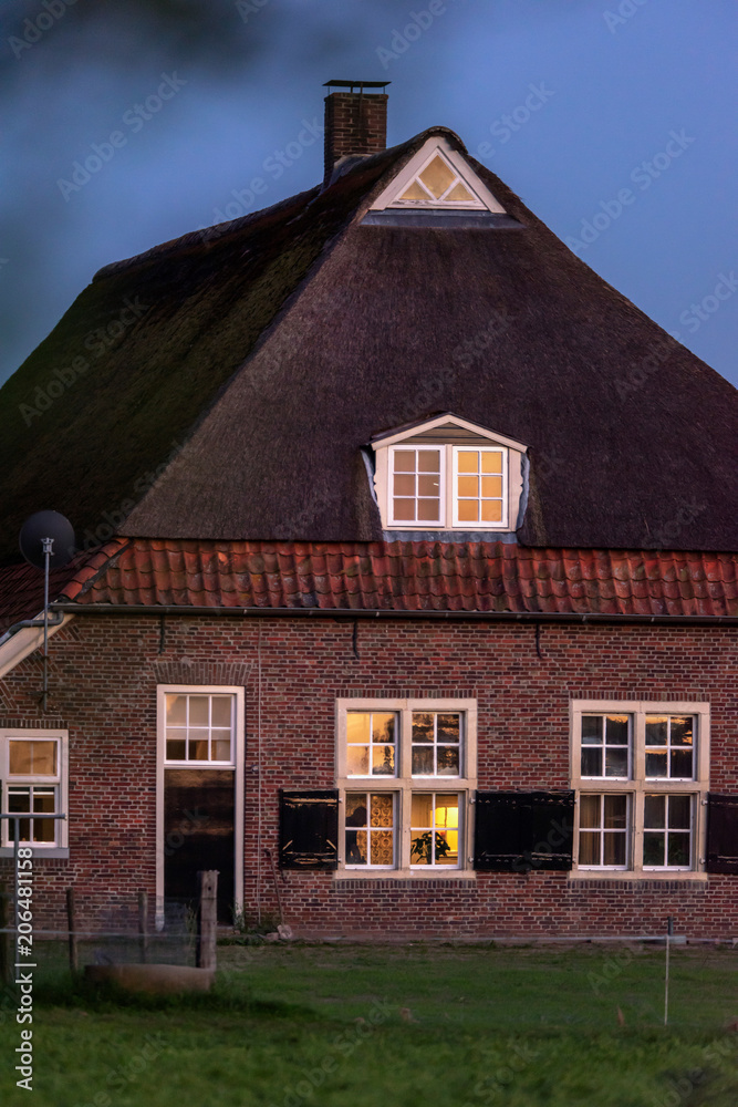 Old dutch farmhouse in evening sun with blue sky. Old dutch farmhouse in evening sun with blue sky.