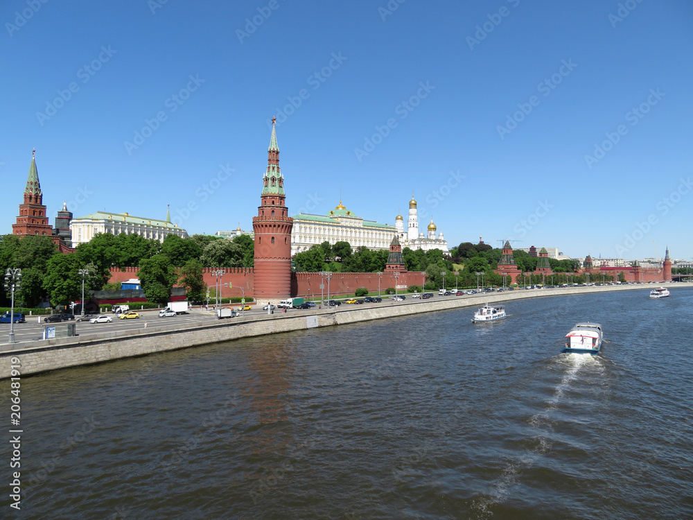 Tourist boats on the Moscow river on the background of the Kremlin towers. Kremlin embankment in summer, russian tourist landmark