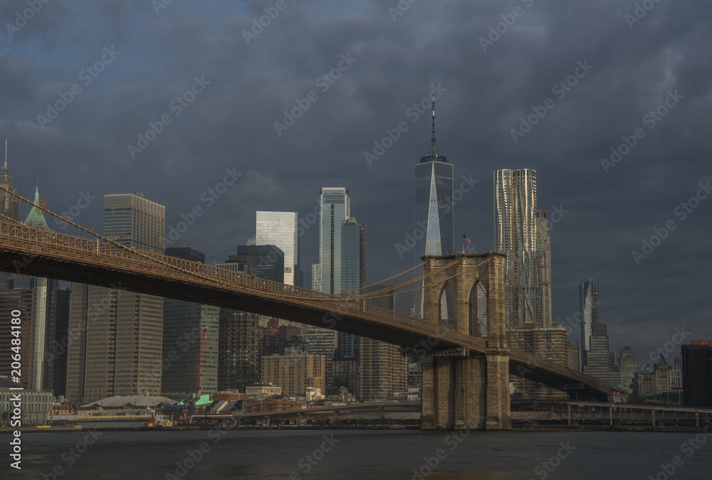 Brooklyn view of Manhattan skyline and Brooklyn Bridge on moody morning