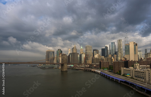 Gloomy morning in New York City. NYC Manhattan financial district skyline and Brooklyn Bridge