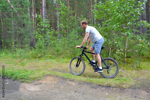 the athlete goes on a bike ride on a cross-country road.Walking on bike.Healthy lifestyle © anwel