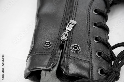 military boots black on the lock and with rivets, sole with a pattern, legs for protection of legs