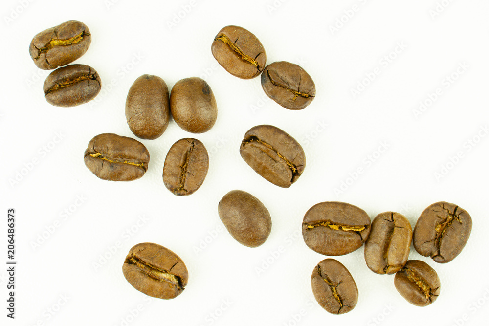 close up of medium or dark roasted coffee beans isolated on white background, can be used as a background or graphic object in your ads. close up of medium or dark roasted coffee beans isolated on white background, can be used as a background or graphic object in your ads.