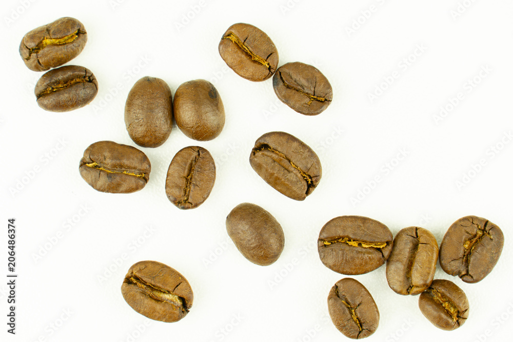 close up of medium or dark roasted coffee beans isolated on white background, can be used as a background or graphic object in your ads.