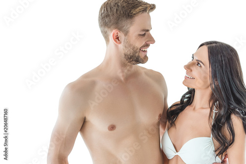 smiling beautiful couple looking at each other, isolated on white