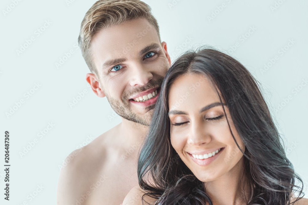 happy young couple standing together, isolated on white happy young couple standing together, isolated on white