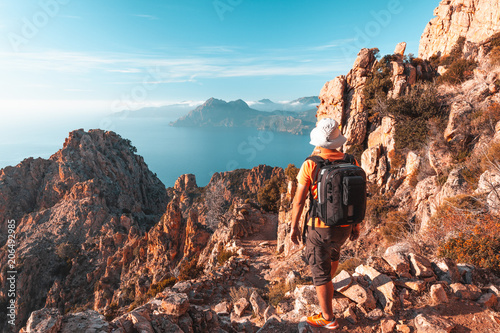 Hiker looking at the view at Calanques de Piana in Corsica, France photo