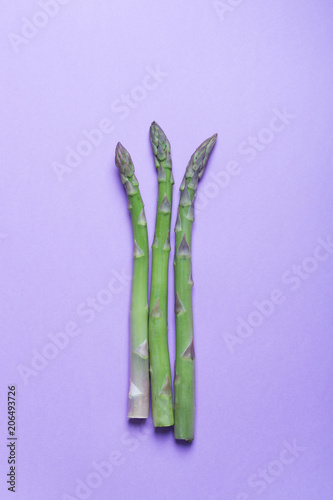 Banches of fresh green asparagus on lilac background