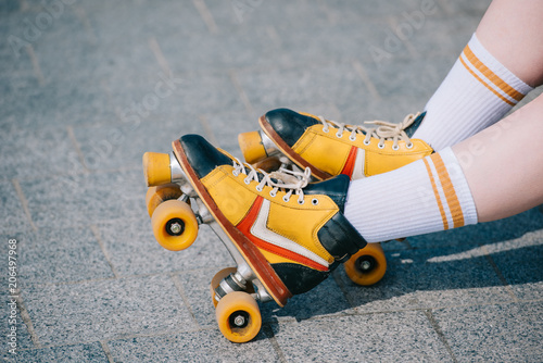 close-up partial view of female legs in vintage roller skates photo