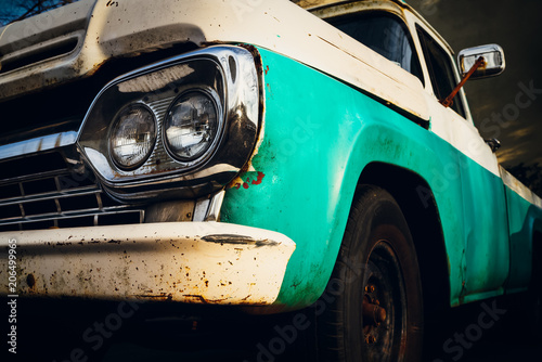 Front end of a vintage truck in the headlights. photo