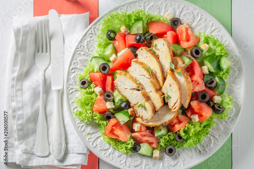 Delicious Caesar salad with chicken, olives and tomatoes