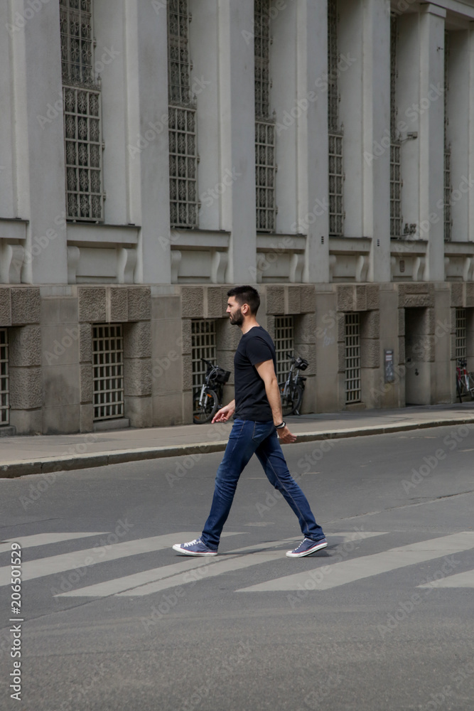 Young man crossing the street 
