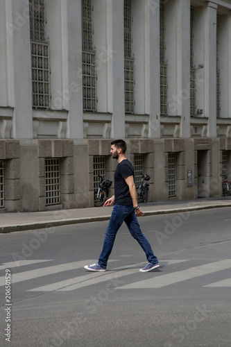 Young man crossing the street 