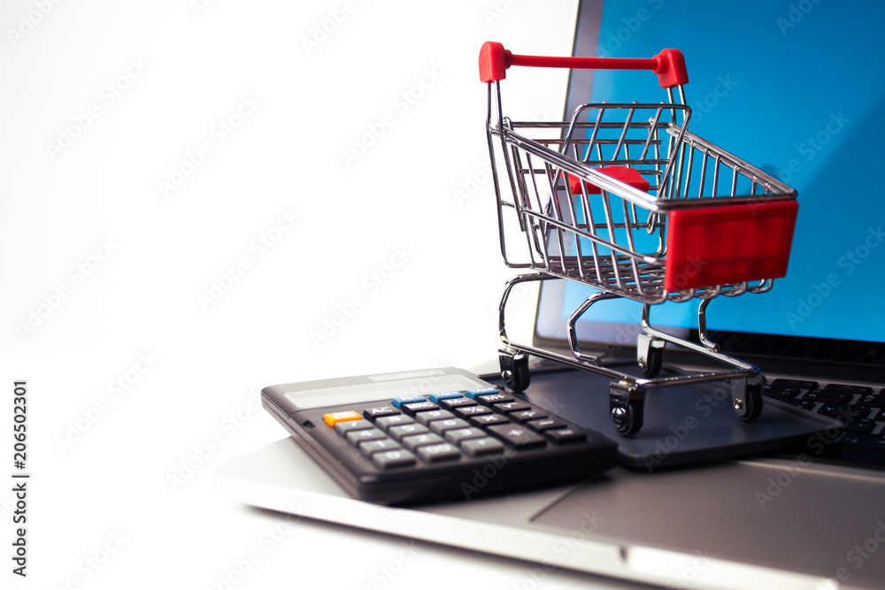 shopping cart with notebook and calculater in online business concept