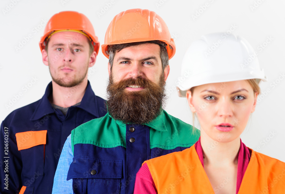 Diversity in collective concept. Woman and men in hard hats Diversity in collective concept. Woman and men in hard hats