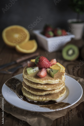 Buckwheat pancakes with berry fruit and honey.
