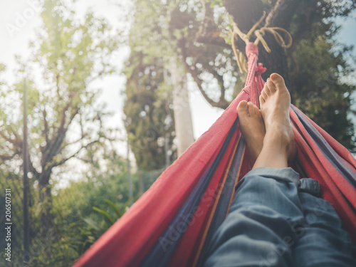 Obraz na plátně nude feet relaxing on hammock in spring season