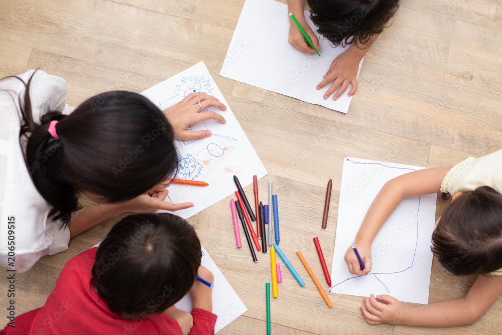 Group of preschool student and teacher drawing on paper in art class. Back to school and Education concept. People and lifestyles theme. classroom in nursery Group of preschool student and teacher drawing on paper in art class. Back to school and Education concept. People and lifestyles theme. classroom in nursery