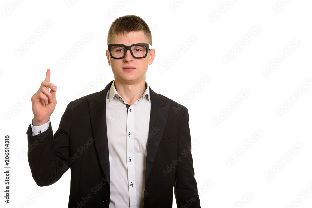 Studio shot of young businessman pointing finger up Studio shot of young businessman pointing finger up