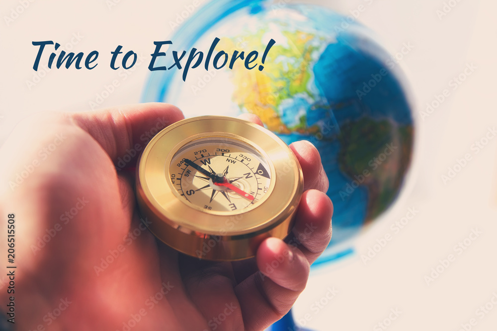 compass in man's hand with the globe on the background . travel and explore concept