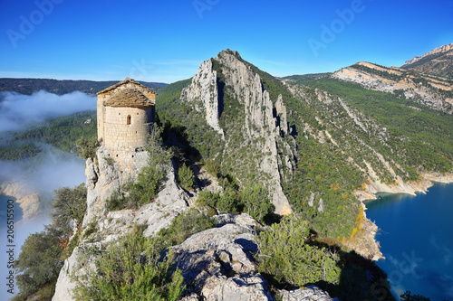 Romanesque Chapel of Mare de Deu de la Pertusa over the Canelles reservoir in Lleida, Catalonia, Spain. photo