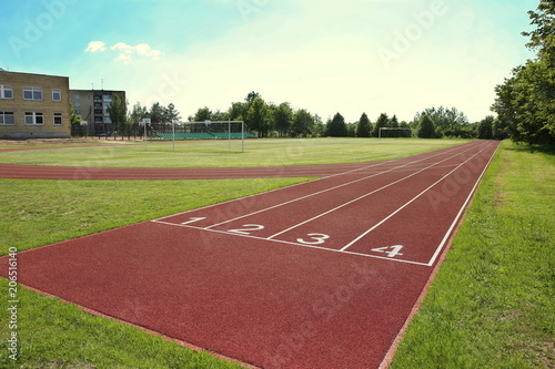 Numbered start track in stadium. Start line with numbers and lanes on running track. © vaitekune