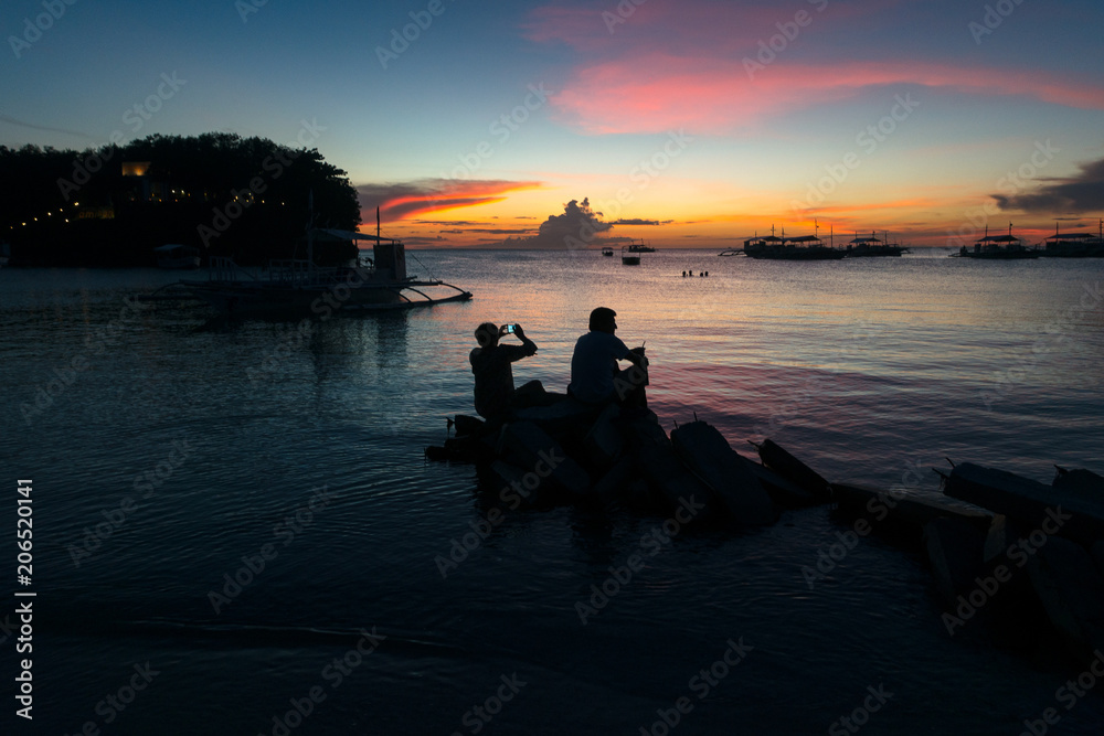 Retired Couple Taking Sunset Pictures at the Beach Retired Couple Taking Sunset Pictures at the Beach