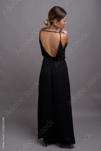 Young beautiful Kazakh woman against gray background