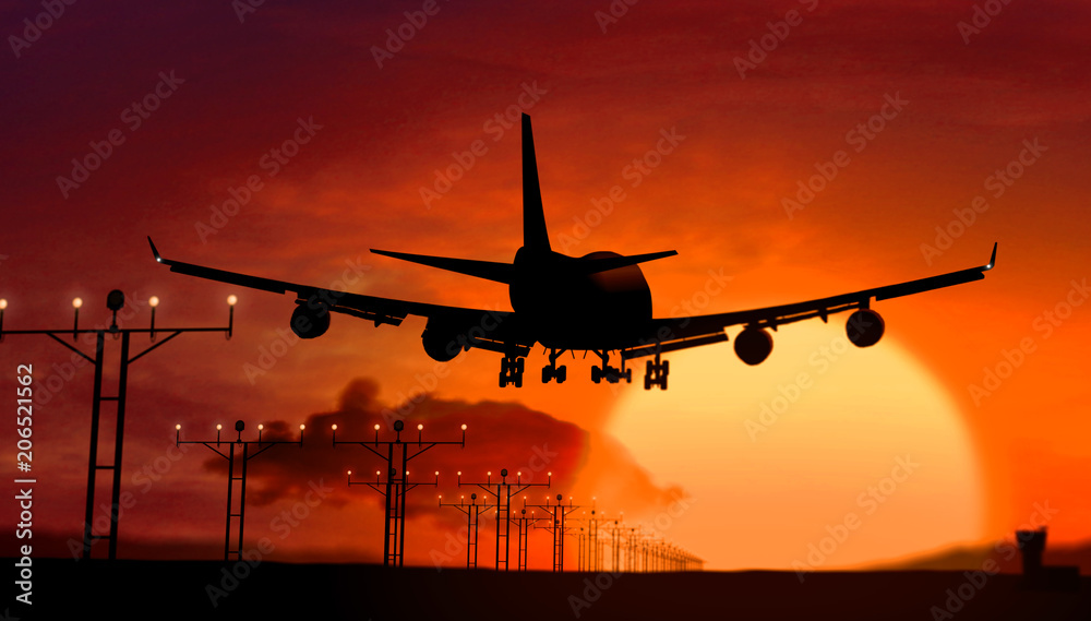 Airplane silhouette landing on sunset