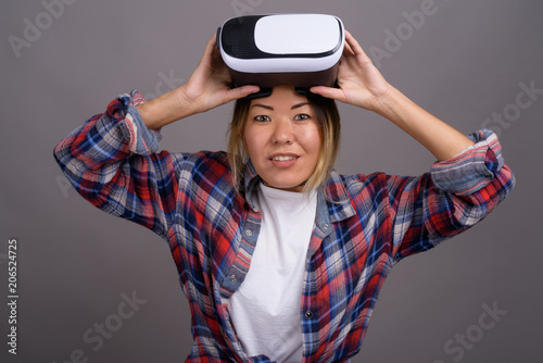 Young beautiful Kazakh woman using virtual reality headset again