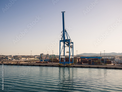 Shipping industrial trade port. Crane bridge and import export container at shipping port harbor.