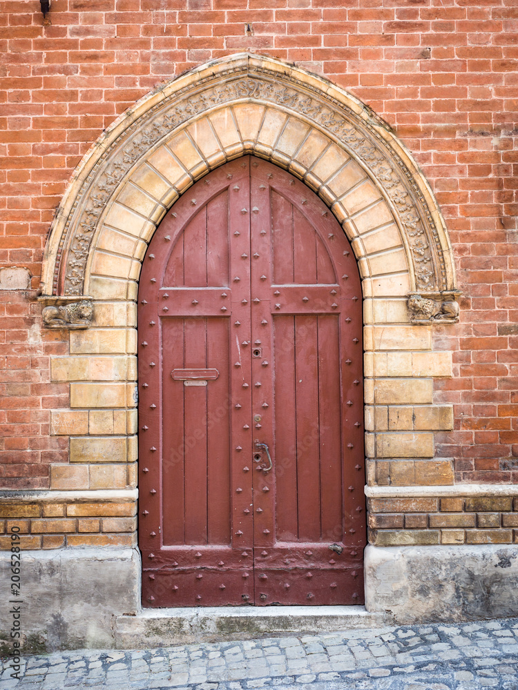Ancient wooden portal with carved stone arch of an Italian medieval fortress. Ancient wooden portal with carved stone arch of an Italian medieval fortress.