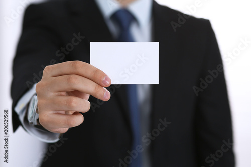 Businessman's hand holding business card with empty space