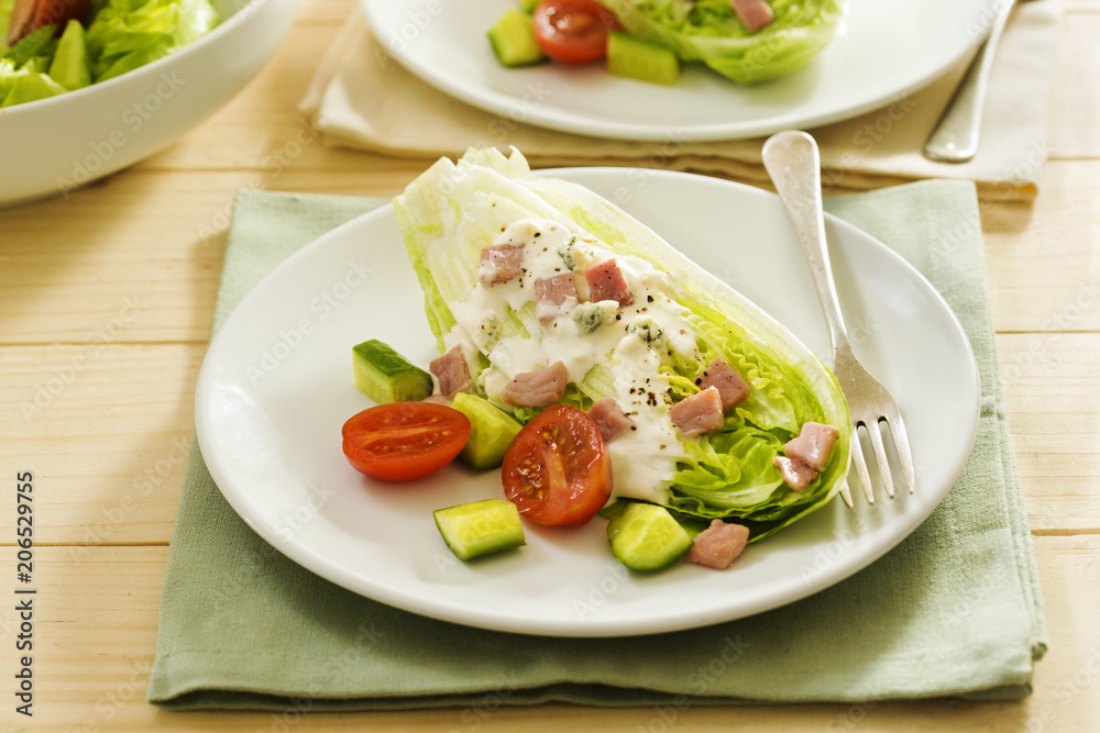 Classic wedge salad with tomatoes, cucumber, bacon and blue cheese dressing Classic wedge salad with tomatoes, cucumber, bacon and blue cheese dressing