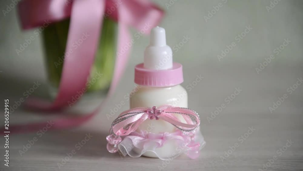 decorative baby bottle with milk are on the table. For a baby shower