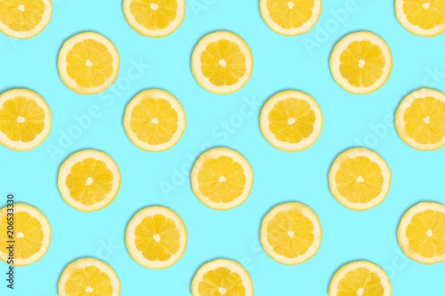 Colorful fruit pattern  Lemon slices on a pastel blue background. Top view.