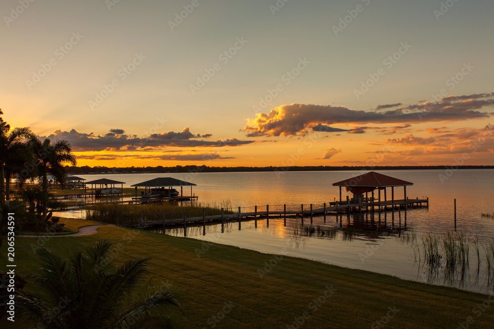 Orange Sunset Overlooking Several Lake Boat Docks
