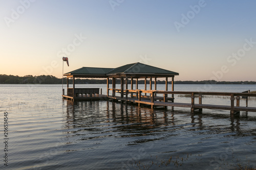 Wooden Lake Boat Dock at Sunset in Calm Water