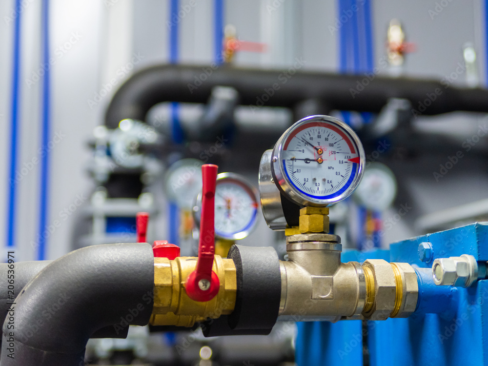 Industrial water temperature and pressure meter on pipe
