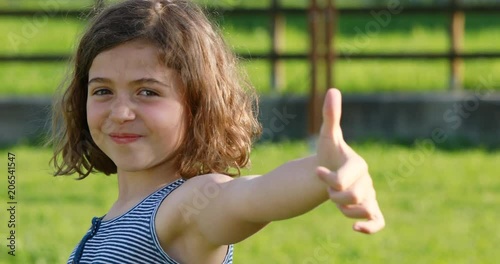 nodding girl shows thumb up