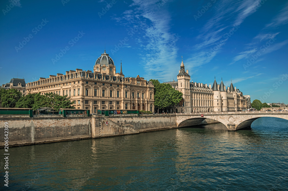 Bridge over the Seine River and the Conciergerie building with sunny blue sky at Paris. Known as the “City of Light”, is one of the most impressive world’s cultural center. Northern France.