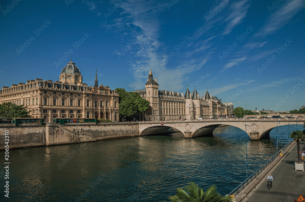 Bridge over the Seine River and the Conciergerie building with sunny blue sky at Paris. Known as the “City of Light”, is one of the most impressive world’s cultural center. Northern France.