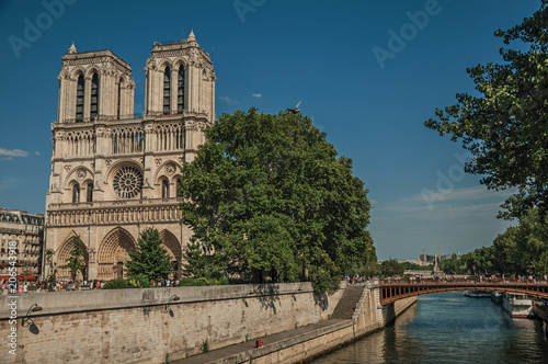 People, tree-lined Seine River and gothic Notre-Dame Cathedral at Paris. Known as the “City of Light”, is one of the most impressive world’s cultural center. Northern France.