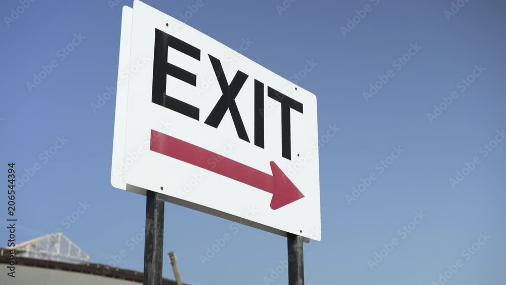 Parking lot exit sign on blue sky background.
Parking lot exit sign on blue sky background.