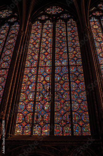 Colorful stained glass windows at the gothic Sainte-Chapelle (church) in Paris. Known as the “City of Light”, is one of the most awesome world’s cultural center. Northern France.