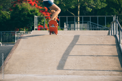 skateboarder skateboarding on skatepark ramp © lzf